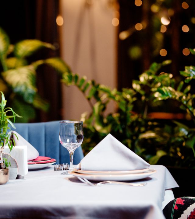 half-empty-restaurant-table-with-plate-glass-cutlery
